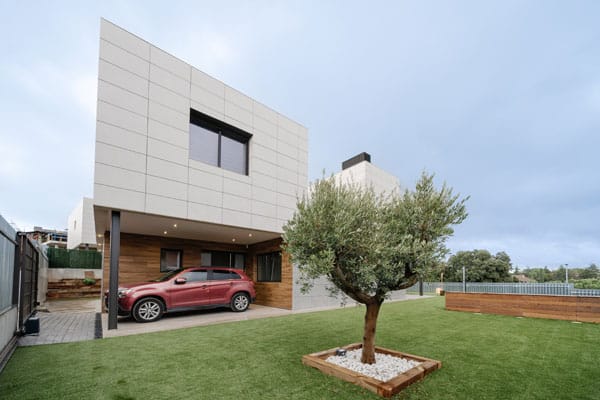 Olivo en casa unifamiliar moderna con porche para el coche
